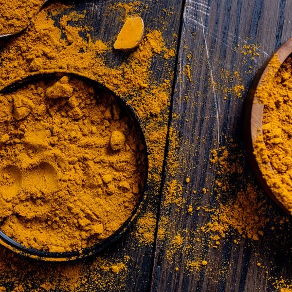 Turmeric powder in rustic bowls, a warming spice for agni
