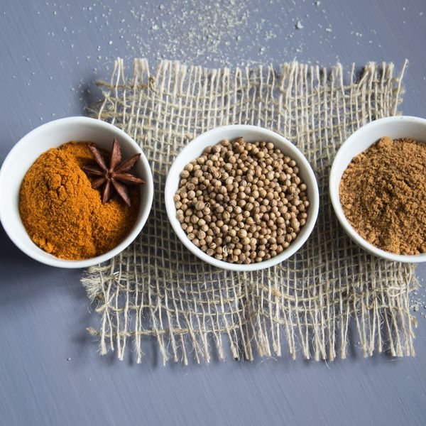 Three bowls of spices representing the three doshas