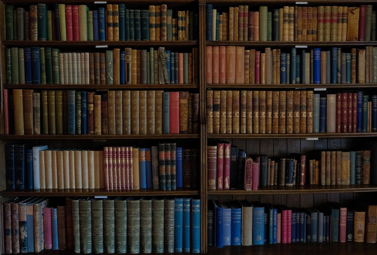 Shelves of old leather-bound books in a library